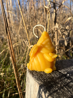This beeswax candle is of a gnome honey bee. The Santa hat has the honeycomb pattern.
