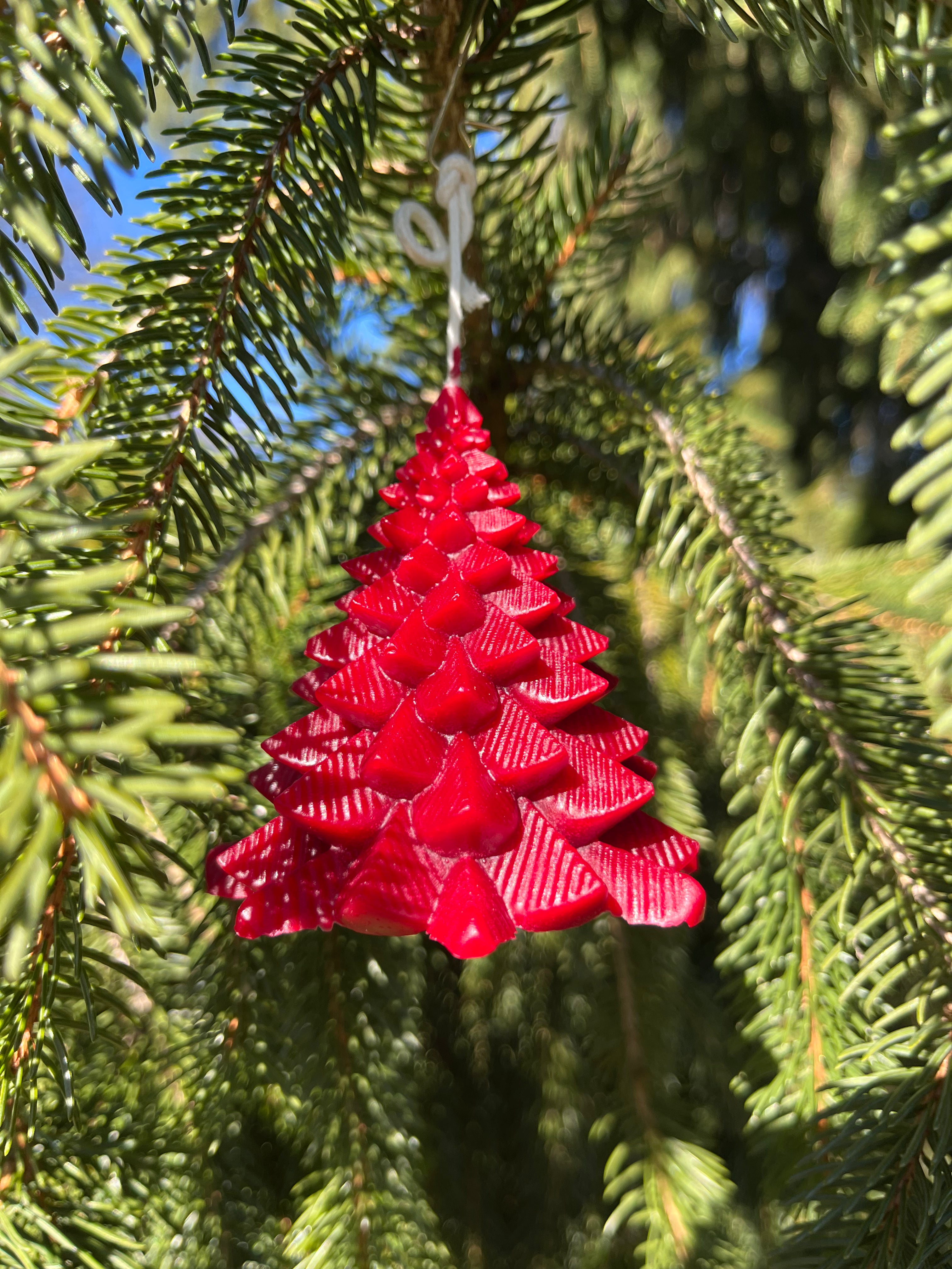 The color red is pronounced on a Christmas tree. Hardwood Honey provides ornament candles for the holiday season. The wick is extended and knotted to a hook. Just cut the wick about a quarter inch above the candle to light. Do not light candles close to or underneath a Christmas tree or anything flammable.