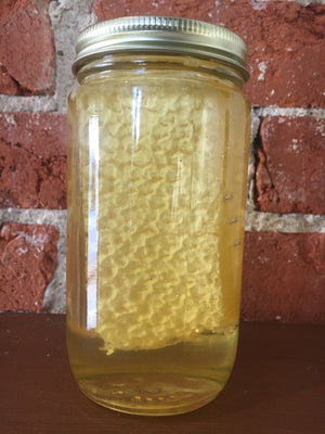 Chunk Honey consists of a slice of honeycomb in a mason jar. Then the mason jar is filled with honey. Providing that golden appeal.
