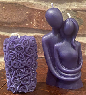The embrace candle in the color purple is stunning next to the rose bush beeswax candle.