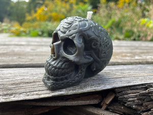 The human skull is decorated for Halloween. Poured with Indiana beeswax, and comes in a variety of colors.