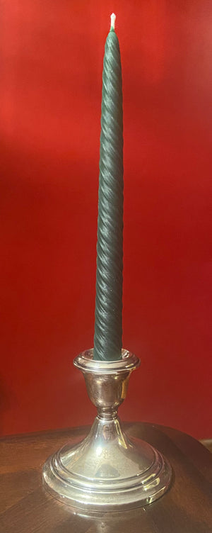 The color green of the spiral taper beeswax candle from Hardwood Honey.