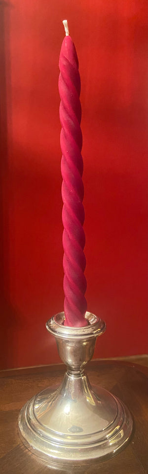 Red twist taper candle in the color red.