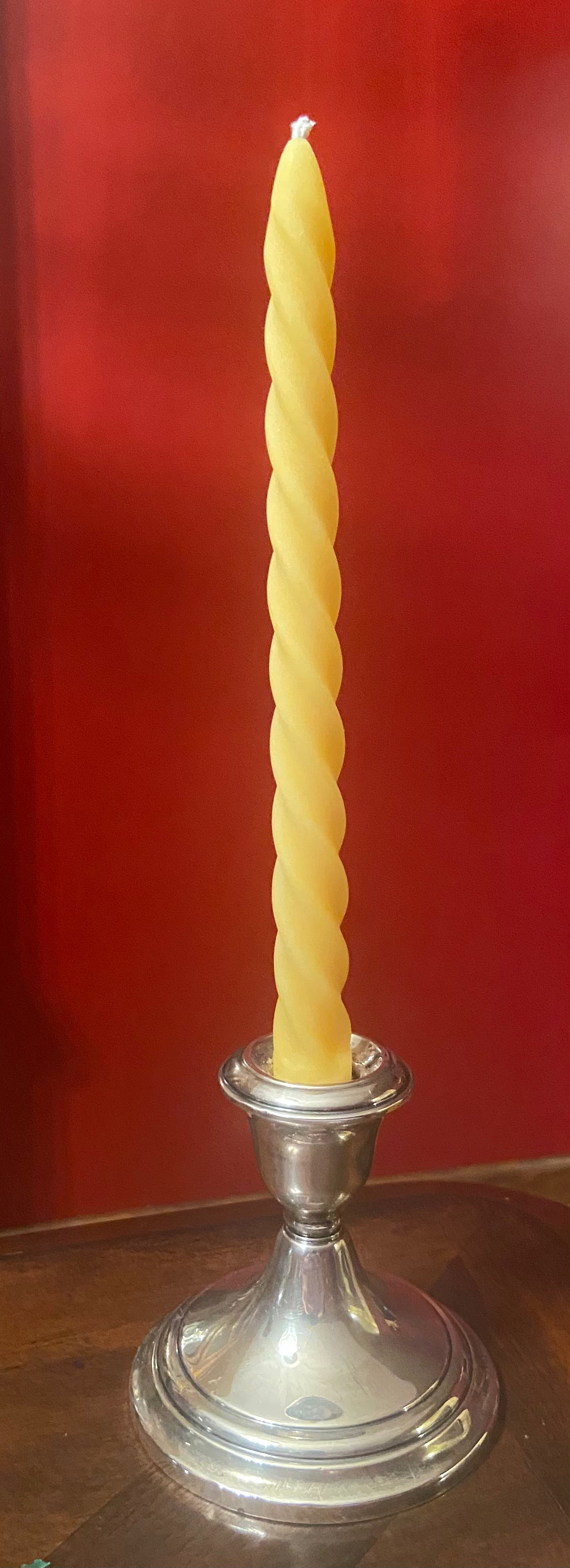 Offered year round, the twist taper candle is shown in the natural beeswax color.