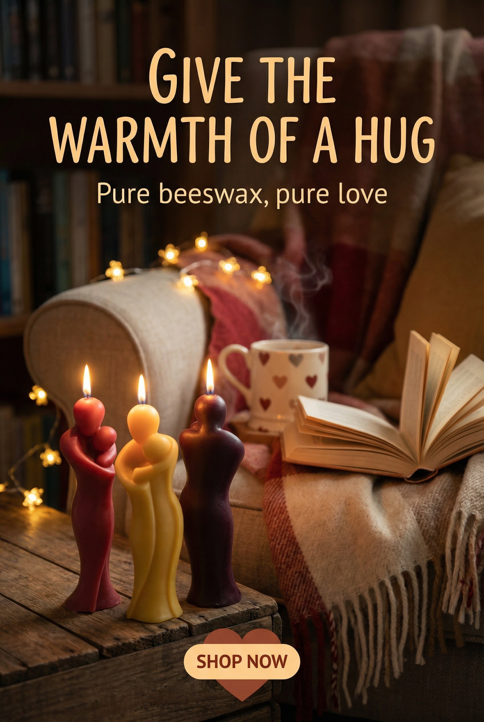 Candle holders shaped like people with lit candles, a mug, book, and blanket on a wooden surface with text 'Give the warmth of a hug'.